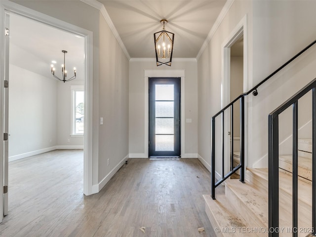 entrance foyer with a wealth of natural light, a notable chandelier, and light hardwood / wood-style floors