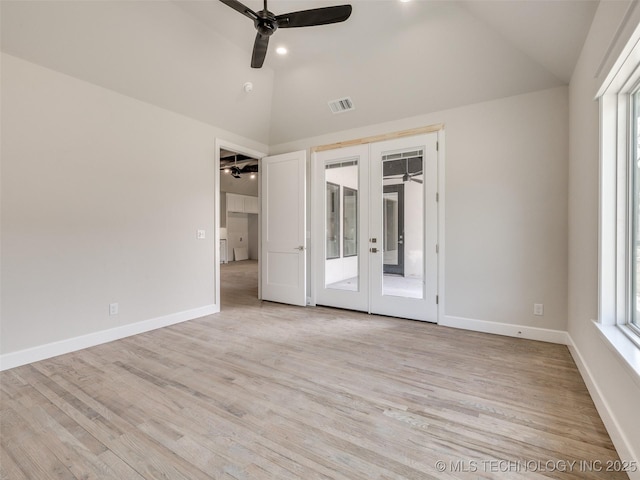 spare room with light hardwood / wood-style floors, lofted ceiling, ceiling fan, and french doors