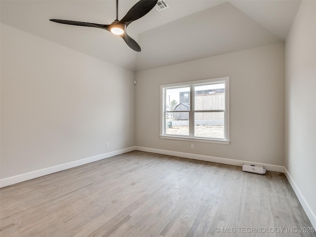 empty room featuring vaulted ceiling, ceiling fan, and light wood-type flooring