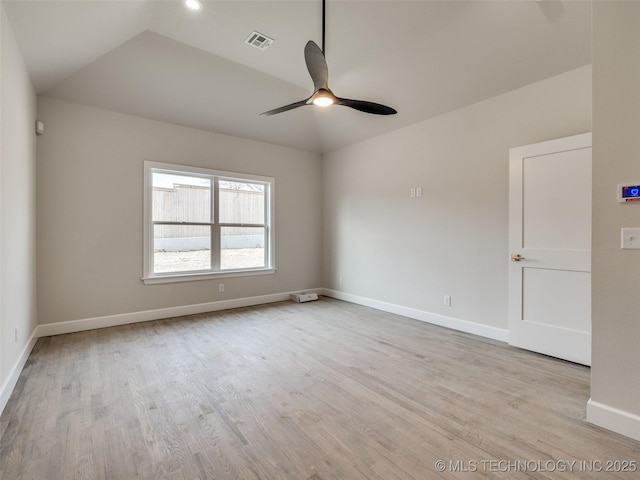 empty room featuring lofted ceiling, ceiling fan, and light wood-type flooring