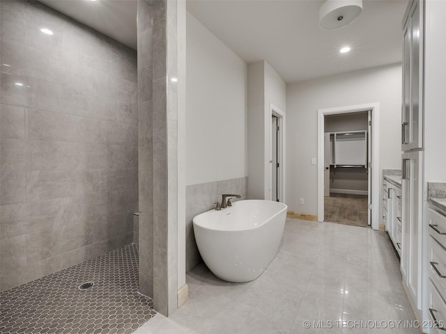 bathroom with independent shower and bath and vanity