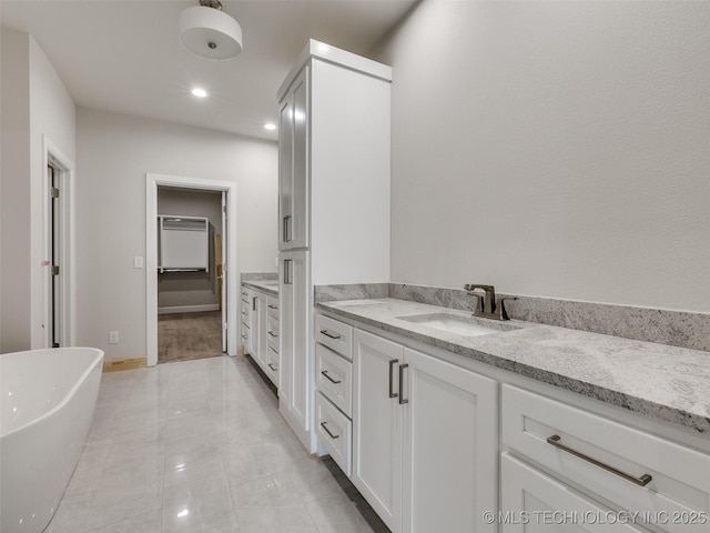 bathroom with vanity and a bath