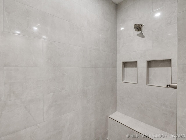 bathroom with a tile shower