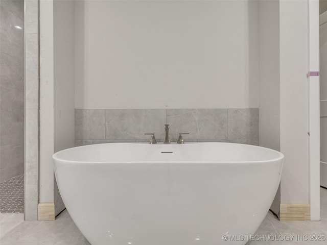 bathroom featuring tile patterned flooring and a bathtub