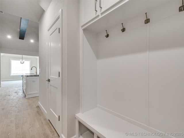 mudroom featuring sink and light wood-type flooring