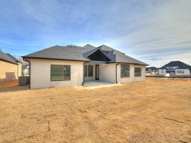 back of property featuring a yard, cooling unit, and a patio area