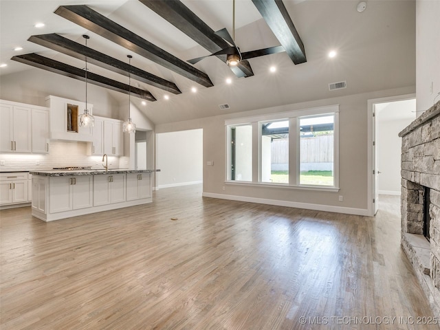 11224 S Fir Ave W, Jenks, OK 74037 - unfurnished living room with ceiling fan, light wood finished floors, a stone fireplace, baseboards, and recessed lighting