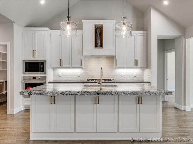 11224 S Fir Ave W, Jenks, OK 74037 - kitchen with oven, lofted ceiling, built in microwave, light stone countertops, and tasteful backsplash