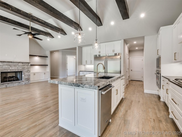 11224 S Fir Ave W, Jenks, OK 74037 - kitchen with built in appliances, white cabinets, beam ceiling, light stone countertops, and high vaulted ceiling