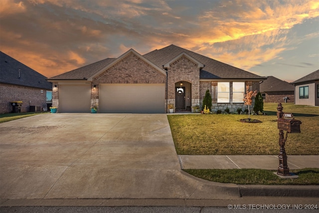 view of front of house with a yard and a garage