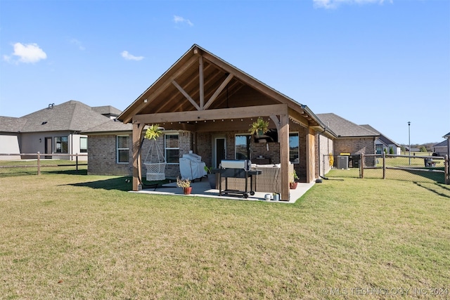 rear view of house featuring cooling unit, a patio area, an outdoor hangout area, and a yard