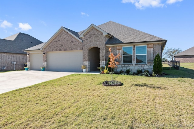 view of front facade with a front yard and a garage