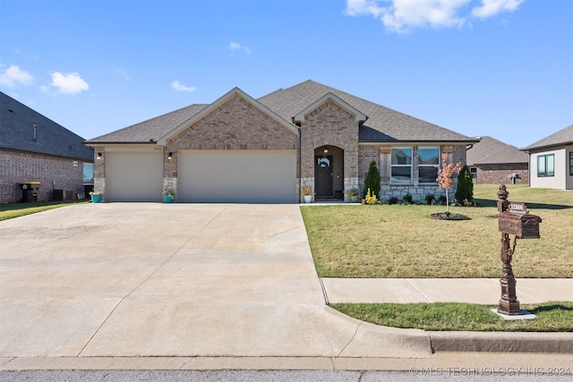 view of front of house featuring a front lawn and a garage