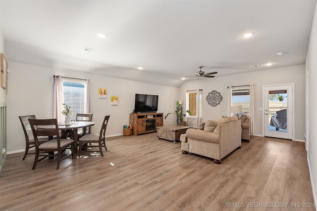 living room with plenty of natural light, light hardwood / wood-style floors, and ceiling fan