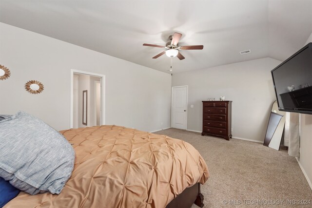 bedroom with ceiling fan, lofted ceiling, and light carpet