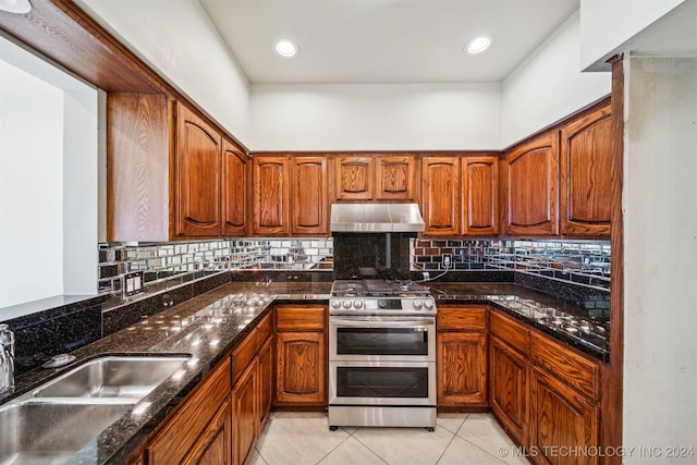 kitchen featuring tasteful backsplash, sink, light tile patterned floors, and double oven range