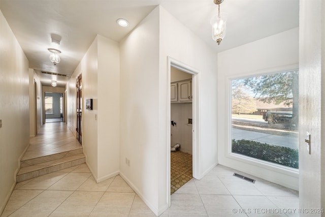 hallway with light tile patterned floors