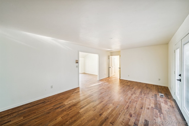 unfurnished room with hardwood / wood-style flooring