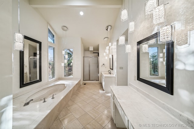 bathroom with tile patterned floors, vanity, and independent shower and bath