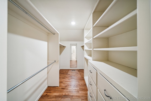 spacious closet with light hardwood / wood-style flooring