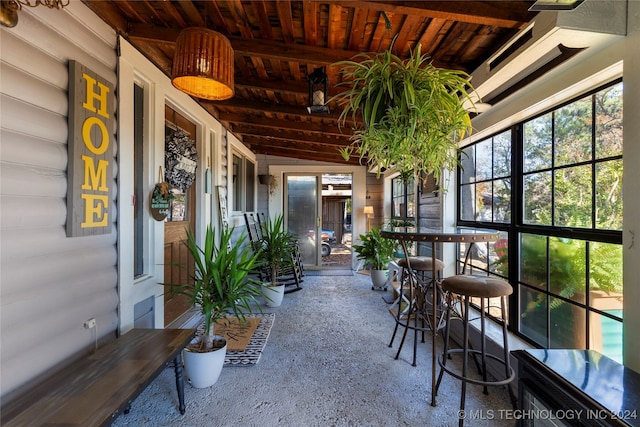 sunroom / solarium with lofted ceiling with beams and wood ceiling