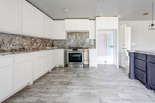 kitchen featuring white cabinets, gas stove, decorative light fixtures, and backsplash