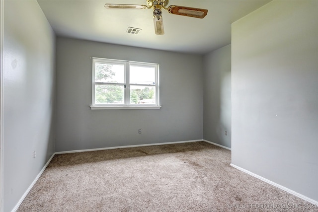 unfurnished room featuring light carpet and ceiling fan