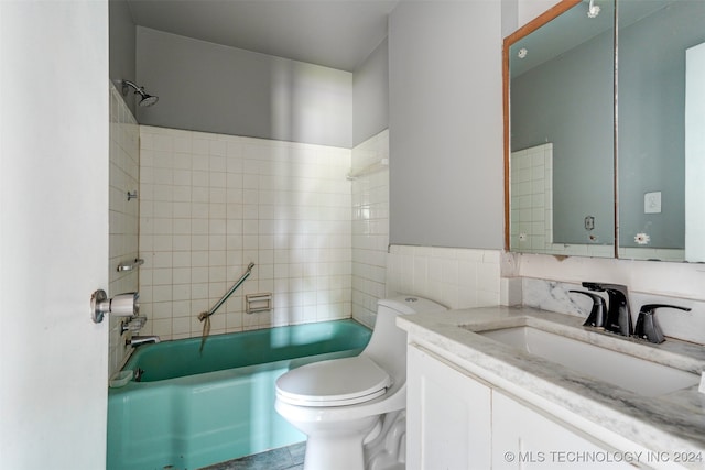 full bathroom with vanity, toilet, and tiled shower / bath