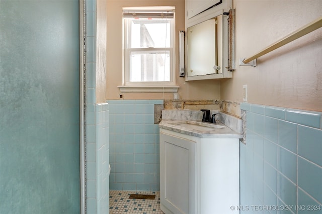 bathroom featuring vanity, tile patterned floors, and tile walls