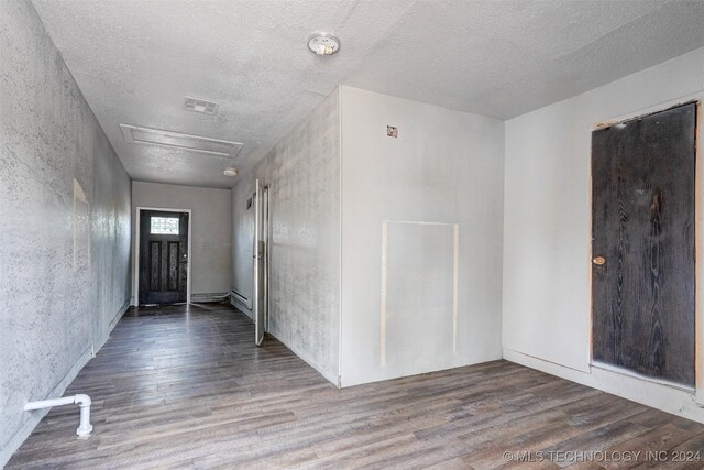 entryway with hardwood / wood-style floors and a textured ceiling