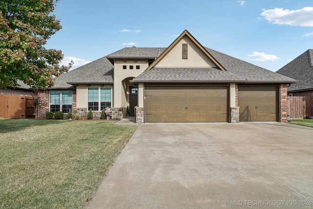 view of front of property featuring a garage and a front lawn