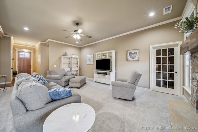 living room featuring light colored carpet, ceiling fan, and ornamental molding