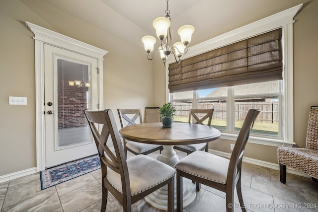 tiled dining space with a chandelier