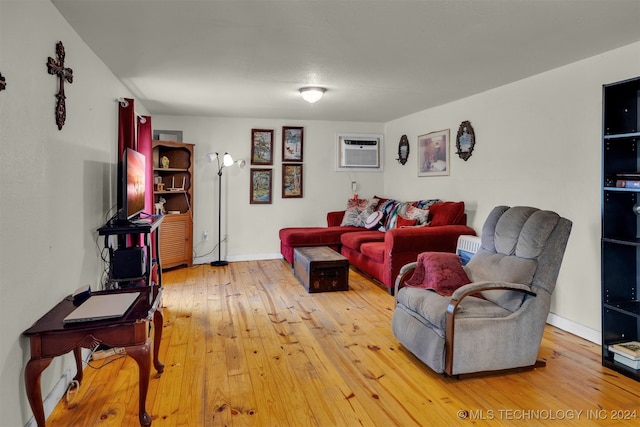 living room with a wall mounted AC and wood-type flooring