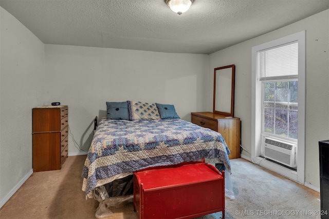 bedroom with a textured ceiling, light colored carpet, and cooling unit