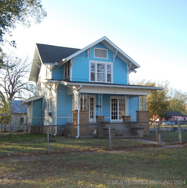 view of front of property featuring covered porch and a front yard