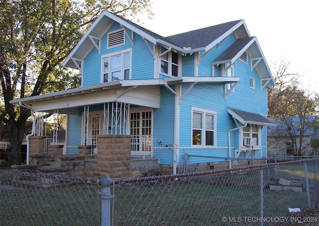 view of front of property with cooling unit and covered porch