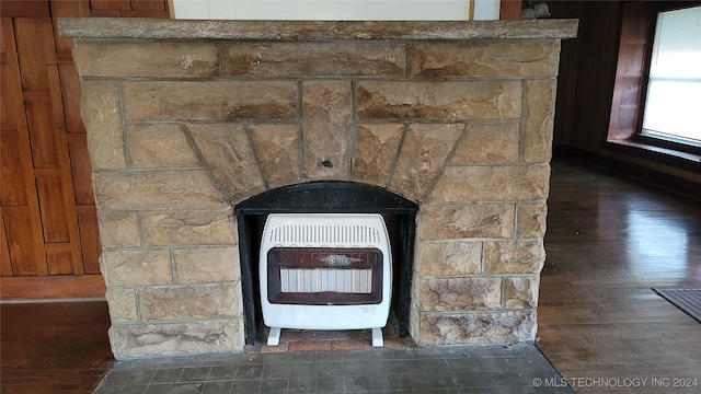 room details with hardwood / wood-style floors and heating unit