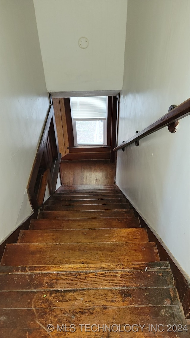 stairs featuring wood-type flooring