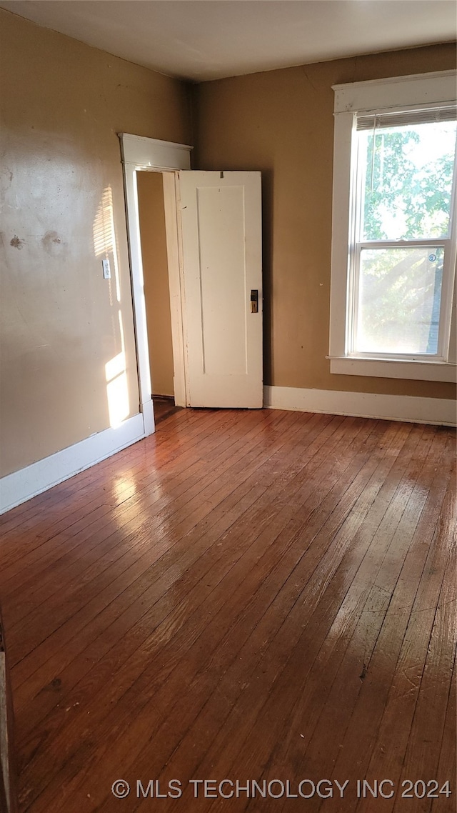 spare room with hardwood / wood-style flooring