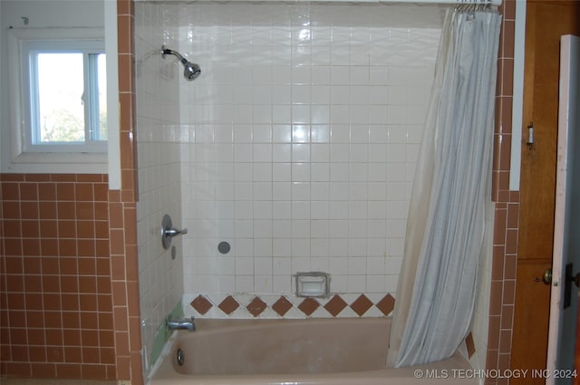 bathroom with shower / bath combination with curtain