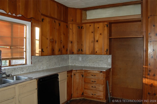 kitchen with black dishwasher and tasteful backsplash