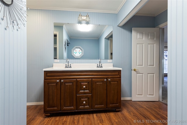 bathroom with vanity, ornamental molding, and hardwood / wood-style flooring