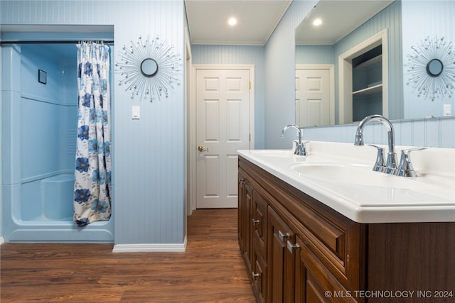 bathroom featuring vanity, ornamental molding, shower / tub combo, and hardwood / wood-style flooring