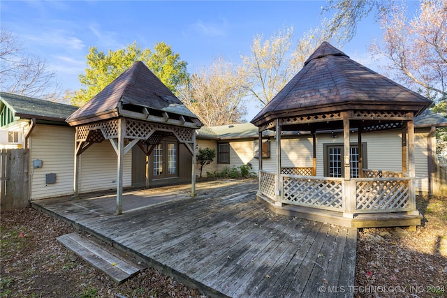 wooden terrace featuring a gazebo and french doors