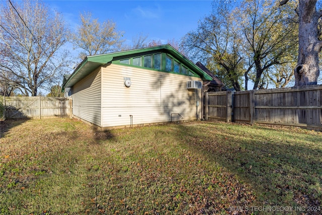 view of side of home with a lawn