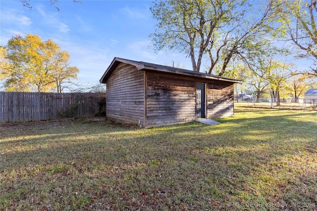 view of outdoor structure featuring a lawn