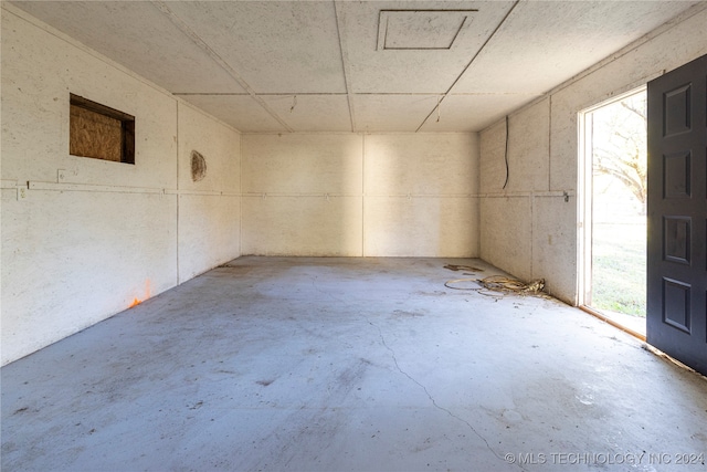 unfurnished room with plenty of natural light and concrete flooring