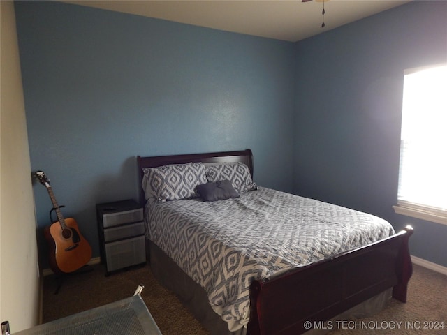 bedroom with dark colored carpet