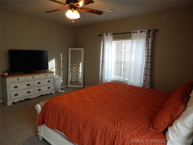 bedroom featuring dark colored carpet and ceiling fan